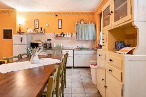 a kitchen with a table and chairs in a room at Casa Vacanze il Ginepro in Sinio +22 photos