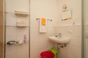 a bathroom with a sink and a shower with towels at Ferienhof Sauter Romanshorn in Neukirch +19 photos