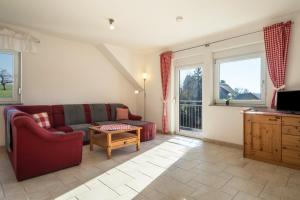 a living room with a couch and a table at Ferienhof Sauter Romanshorn in Neukirch