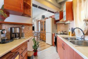 a kitchen with wooden cabinets and a sink at Victoria's House in Gaios