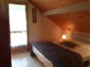 a bedroom with a large bed and a window at Maison de vacances Proche Arcachon in La Teste-de-Buch