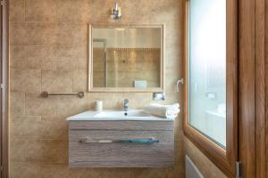 a bathroom with a sink and a mirror at Villa Felicità in Sorso +33 photos