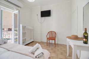 a room with a bed and a table and a tv at M3 room in Nikiana