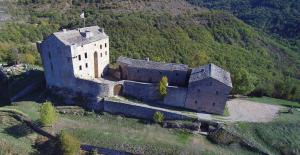 an old castle in the middle of a mountain at Appartement Authentique Montaigut in Gissac