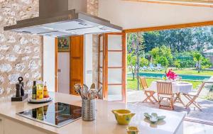 a kitchen with a stove top oven next to a table at Casa Futbol in Sóller