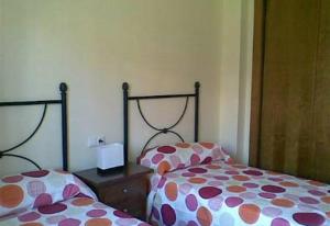 a bedroom with two beds with polka dot sheets at 2 bed apartment with pools and spa in Vera +14 photos
