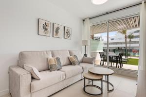 a living room with a couch and a table at Horus Beach Paradise in Torre del Mar