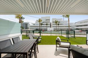 a balcony with a table and chairs and a park at Horus Beach Paradise in Torre del Mar