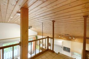 a room with a wooden ceiling and a staircase at Ferienhaus am Wald mit Südblick in Steina