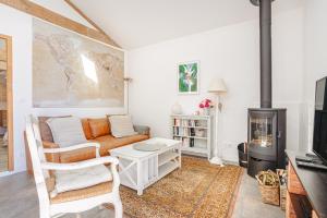 a living room with a couch and a fireplace at Gite La Grange Hulotte in Chaillé-les-Marais