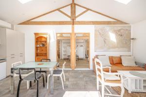 a living room with a table and a couch at Gite La Grange Hulotte in Chaillé-les-Marais