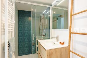 a bathroom with a sink and a glass shower at Gite La Grange Hulotte in Chaillé-les-Marais +17 photos