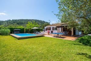 a backyard with a pool and a house at Can Amer in Pollença