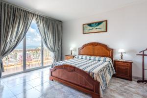 a bedroom with a bed and a balcony at Tresa in Lloret de Mar