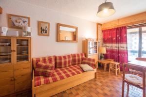 a living room with a couch and a table at Serre-chevalier Vallée - Briançon in Briançon