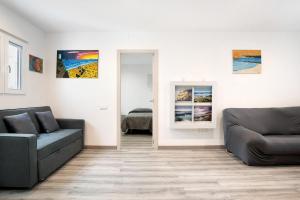 a living room with a couch and a chair at Piso Pablo in Barbate