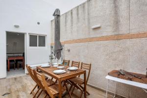 a dining room with a wooden table and chairs at Piso Pablo in Barbate