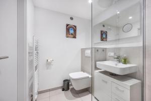 a white bathroom with a sink and a toilet at Al Mare in Wunstorf +15 photos
