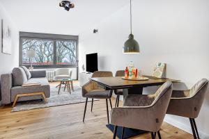 a living room with a dining room table and chairs at Al Mare in Wunstorf