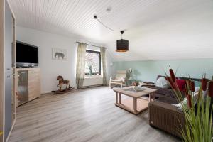 a living room with a couch and a table at Harmonie Hof in Oyten