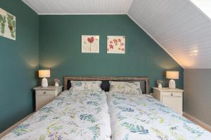 a bedroom with a large bed with two night stands at Harmonie Hof in Oyten