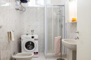 a bathroom with a washing machine and a sink at Casa la Fortezza in Porto Santo Stefano +22 photos