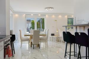 a kitchen and dining room with a table and chairs at Luxusvilla Neubau 1 in Oberasbach