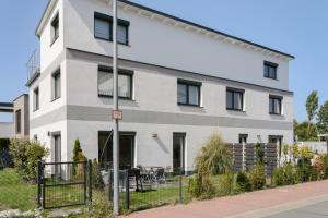 a white building with black windows at Luxusvilla Neubau 1 in Oberasbach