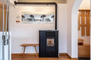 a black fireplace in a room with a wooden table at Apartement Santner in Siusi