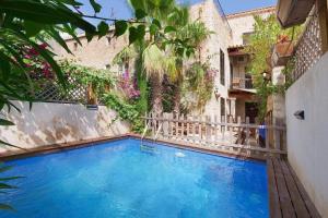 a large blue swimming pool next to a building at Can Teresa in Capdepera