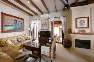 a living room with a couch and a fireplace at Can Teresa in Capdepera