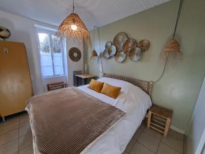 a bedroom with a bed in a room at L'instant Terrière,maison de charme in La Tranche-sur-Mer +3 photos