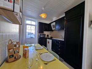 a small kitchen with a table with glasses on it at L'instant Terrière,maison de charme in La Tranche-sur-Mer