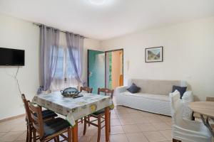a living room with a table and a couch at Il Frutteto 50 in Ortovero