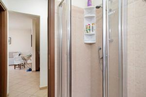 a shower with a glass door in a bathroom at Il Frutteto 50 in Ortovero +16 photos