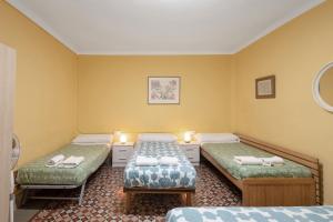 a room with two beds and two candles in it at Masia Cal Vies in Castellví de la Marca