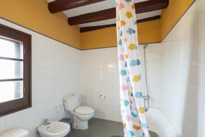 a bathroom with a toilet and a sink at Masia Cal Vies in Castellví de la Marca +31 photos