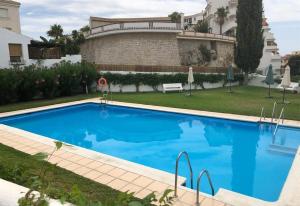a large blue swimming pool in front of a building at Casa Chana in Almuñécar