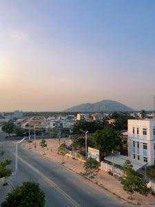 an empty street in a city with a mountain at Mimosa 5 Hotel - Phan Rang in Bắc Sớn +9 photos