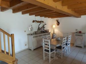 a dining room with a table and chairs at Séjour Nature à Campan in Campan +8 photos