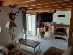 a living room with a couch and a fireplace at Séjour Nature à Campan in Campan