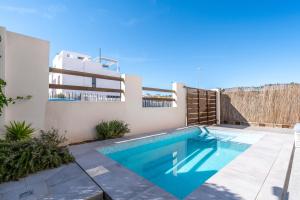 a swimming pool in the backyard of a house at Chalet con Piscina in Orihuela Costa