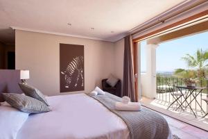 a bedroom with a bed and a large window at Villa Arcadia in San Jose +16 photos