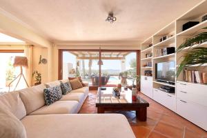 a living room with a couch and a coffee table at Villa Arcadia in San Jose