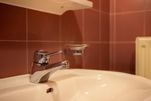 a sink with a faucet in a bathroom at Apartment 2 - Zur Sonne in Laion +12 photos