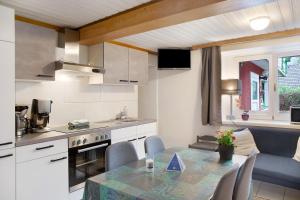 a kitchen and dining room with a table with chairs at Wasserfall in Stall