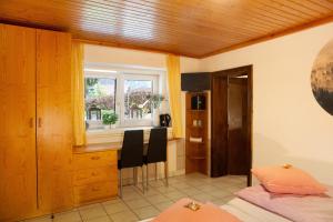 a bedroom with a bed and a kitchen with a window at Wasserfall in Stall +26 photos