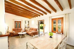 a living room with a table and a couch at Villa Barraca in Pollença