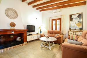 a living room with a couch and a table at Villa Barraca in Pollença
