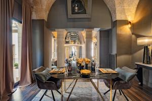 a dining room with a table and chairs at Maison boutique At Pietro in San Pietro in Lama